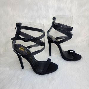 Strappy black suede lace up heeled sandals.